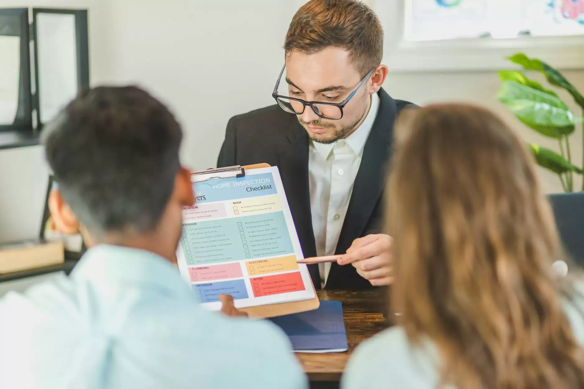 real estate agent discussing and explaining a document to a couple